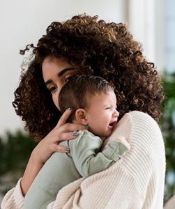 Mom soothes crying baby
